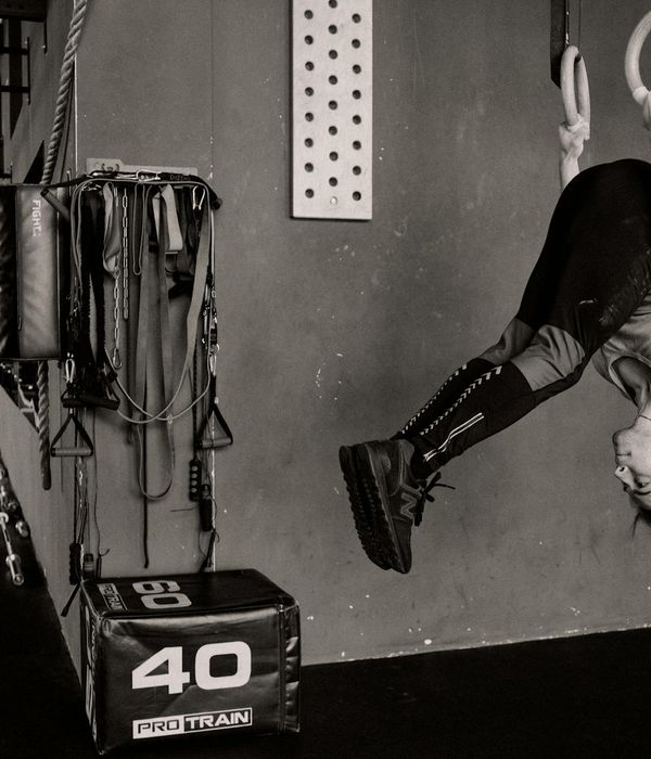Man performing strength exercises in a dark atmospheric gym